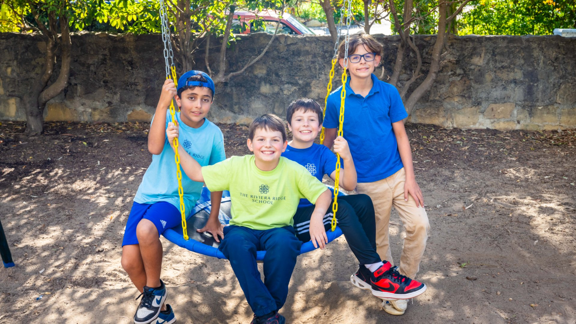 Students on a swing in the Riviera Ridge School outdoor facilities.